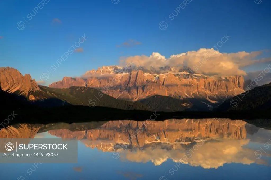 Sella range reflecting in a mountain lake, Val Gardena, Dolomites, UNESCO world heritage site Dolomites, South Tyrol, Italy