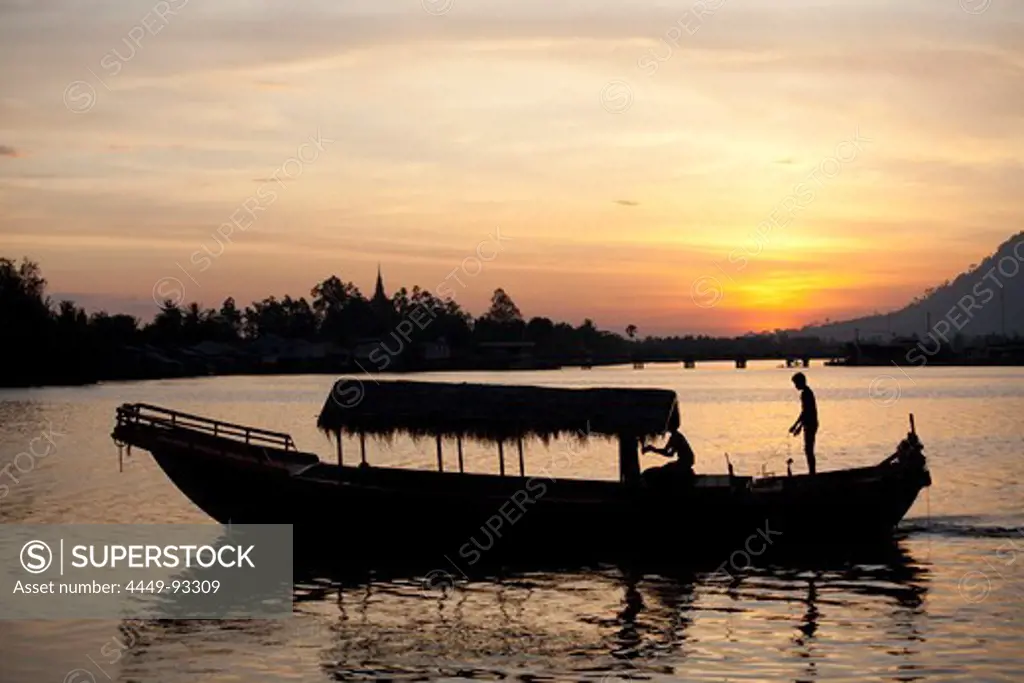 Fishing boat at sunset in Kampot at the Prek Thom River, Kampot province, Cambodia, Asia