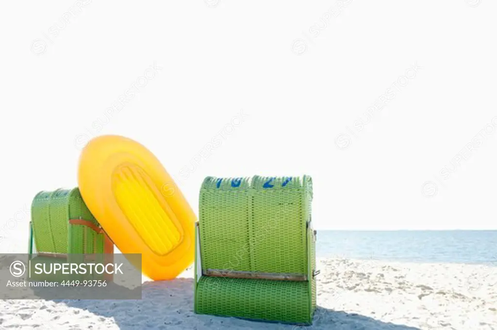 Green beachchairs and yellow rubber dinghy on the beach, Wyk, Foehr, North Frisian Islands, Schleswig-Holstein, Germany, Europe