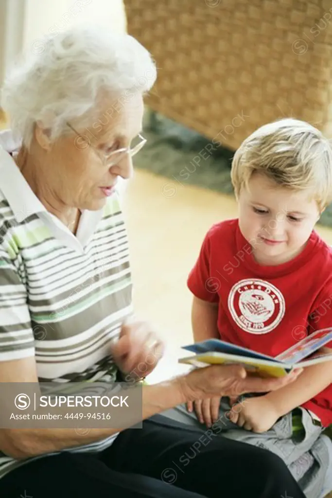 Grandmother and grandchild reading a book together