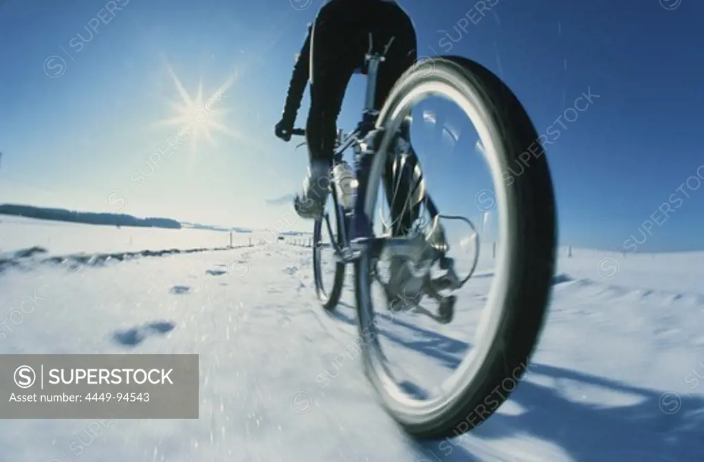 Mountainbiker in snow, 5 Lakes District, Upper Bavaria, Germany