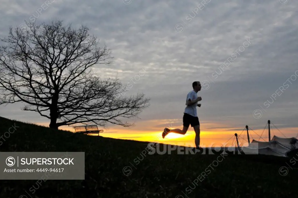 Man jogging, Sunset at the Olympic Park, Munich, Germany