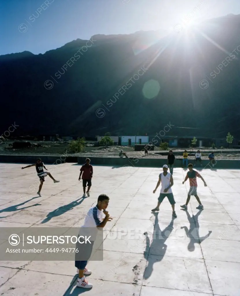 Boys playing football in the sunlight, Portela, Cha das Caldeiras, Island of Fogo, Ilhas do Sotavento, Republic of Cape Verde, Africa
