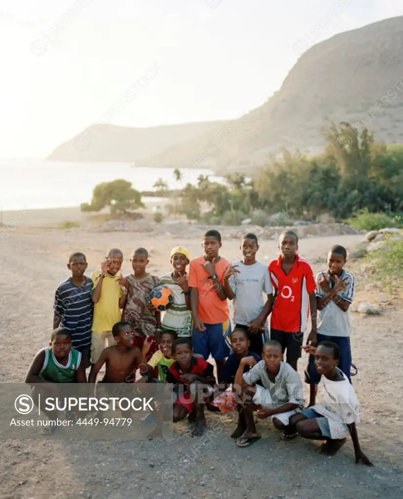 Group of football playing boys in the bay of Tarrafal, Santiago island, Ilhas do Sotavento, Republic of Cape Verde, Africa