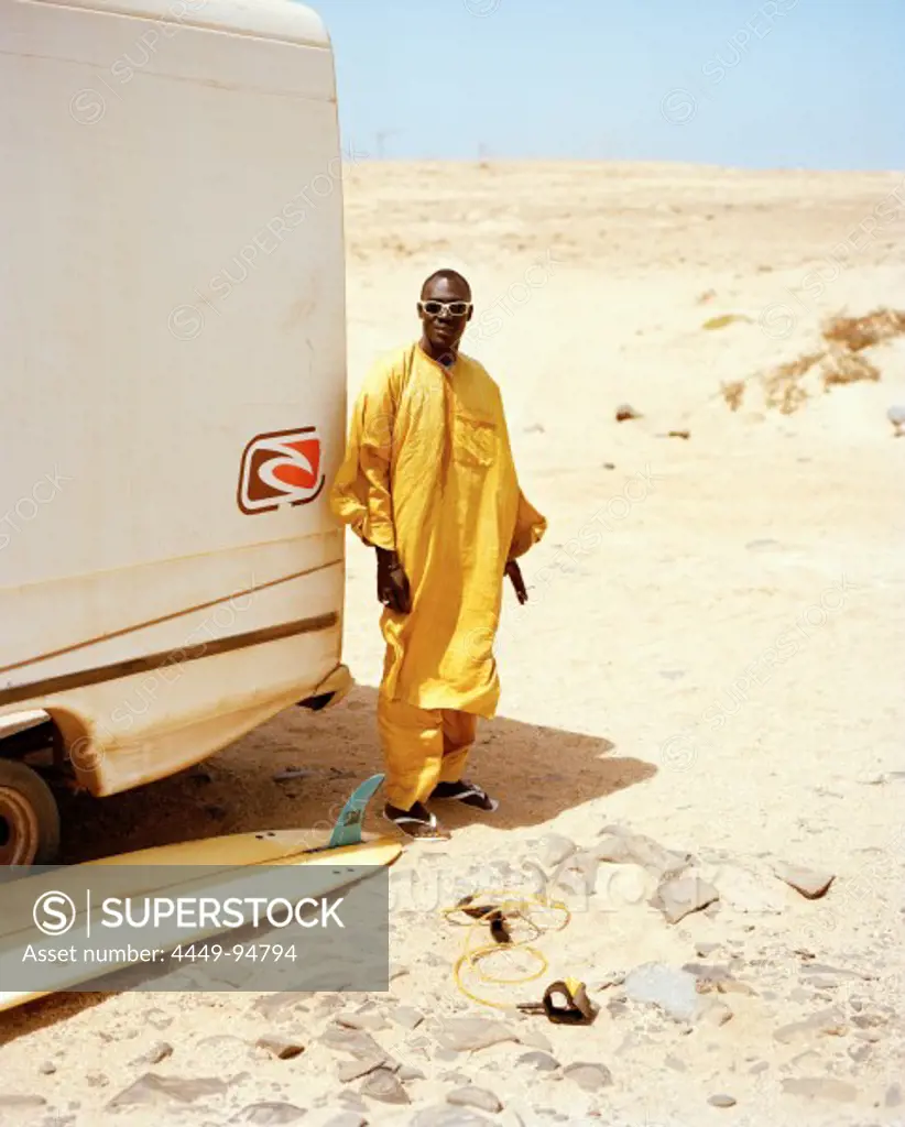 Senegalese musician in front of Joao's surf truck, surf spot Ponta Preta, west of Santa Maria, Sal, Ilhas de Barlavento, Republic of Cape Verde, Africa