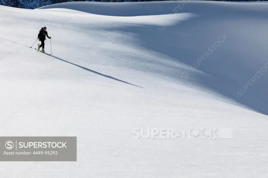 Backcountry skier at Hohe Gruben, ascending Schoentalspitz, Sellrain, Innsbruck, Tyrol, Austria