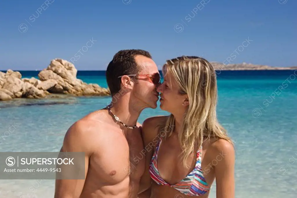 Couple at Spiaggia Capriccioli, Costa Smeralda, Sardinia, Italy