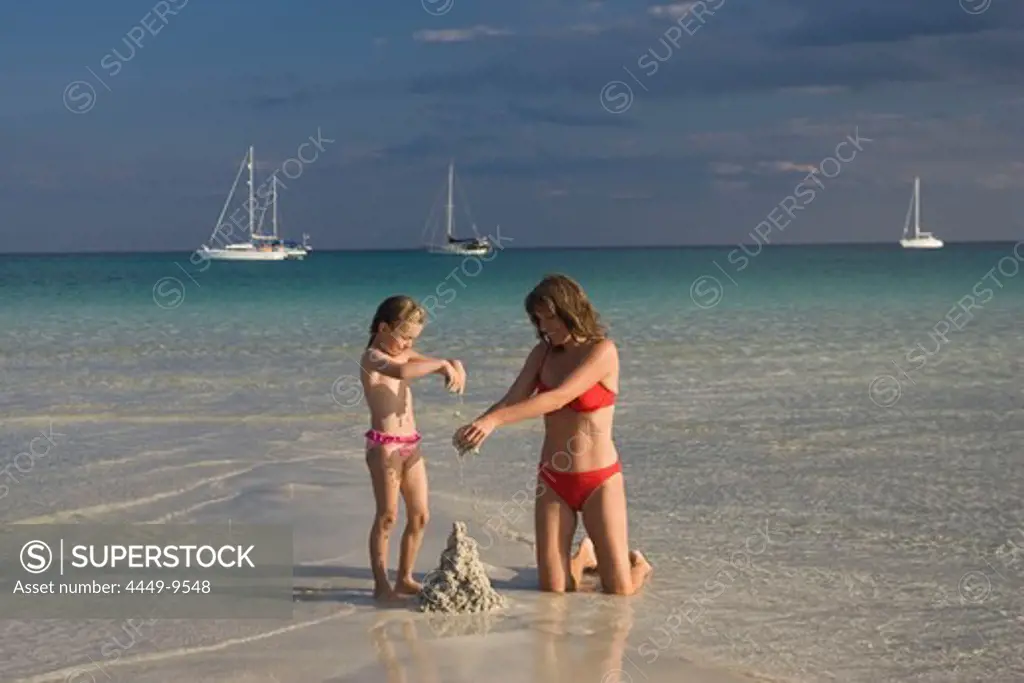 Mother and child playing at beach, Cala Brandinchi, Sardinia, Italy