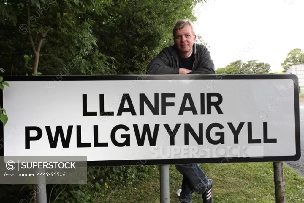Placename sign of Llanfair Pwllgwyngyll and photographer Tilman Schuppius, North Wales, Great Britain, Europe