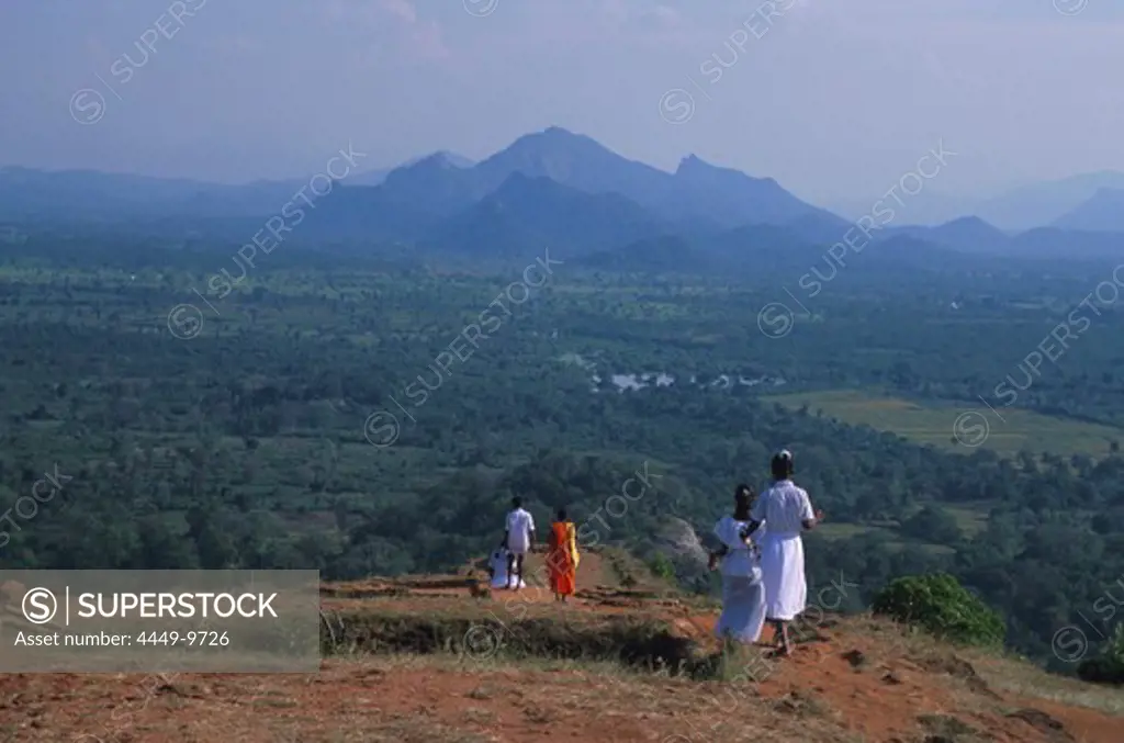 People looking at monsoon forest and Sigiriya rock, Sigiriya. Sri Lanka, Asia