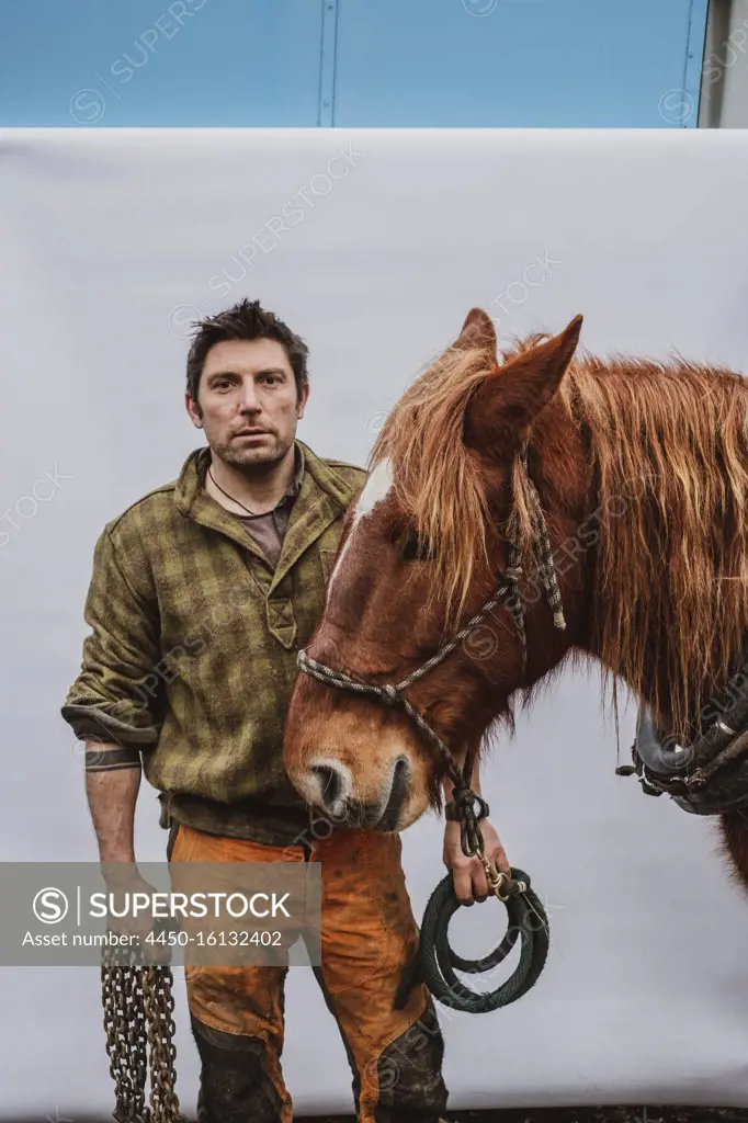 Portrait of a logger with one of his work horses.