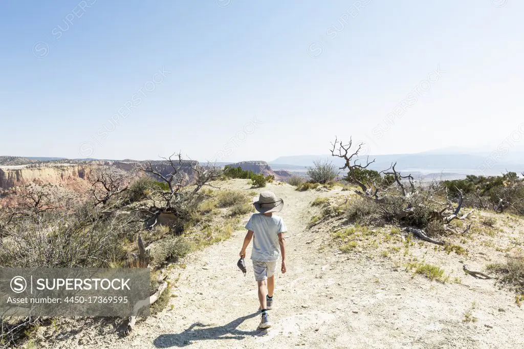 young boy hiking on Chimney Rock trail, through a protected canyon landscape