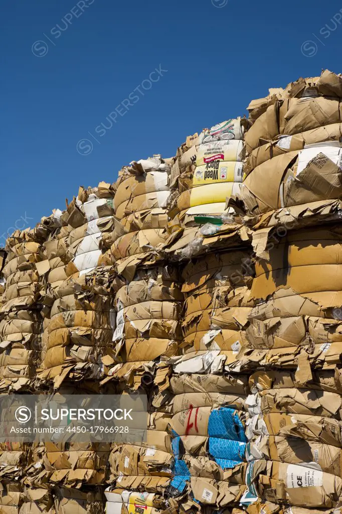Commercial waste management, bales of recycling materials, cardboard stacked up.