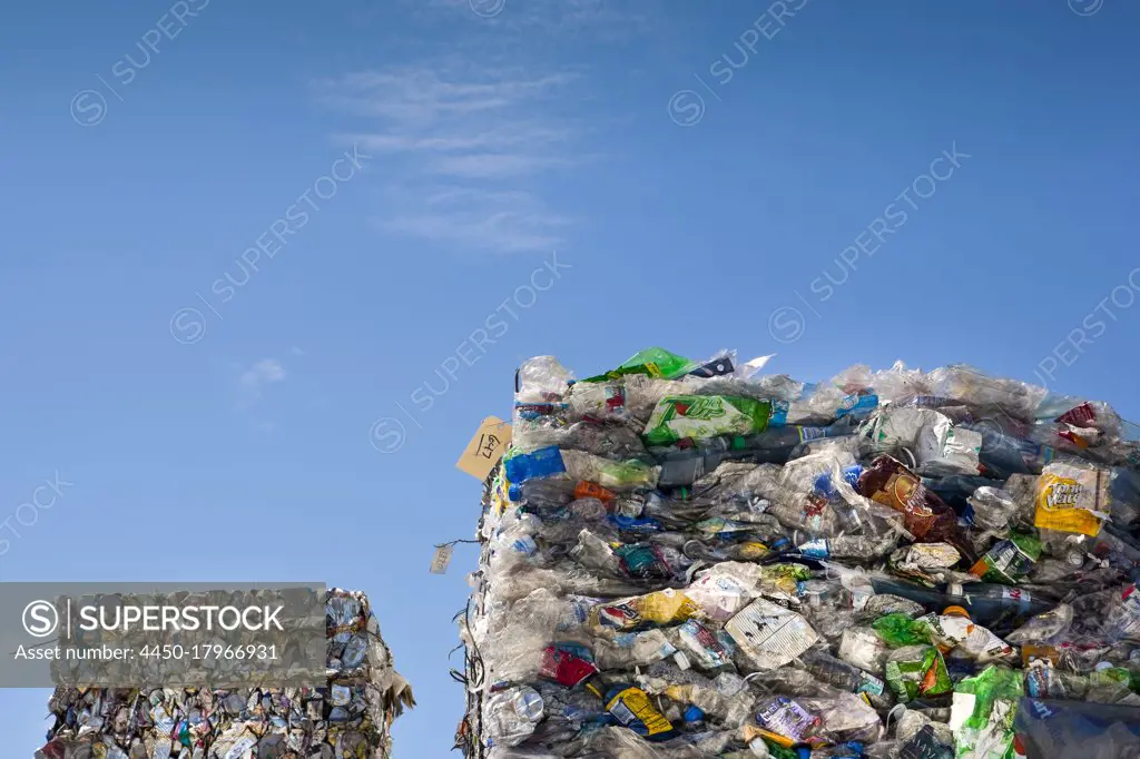 Commercial waste management, bales of recycling materials, plastics stacked up.