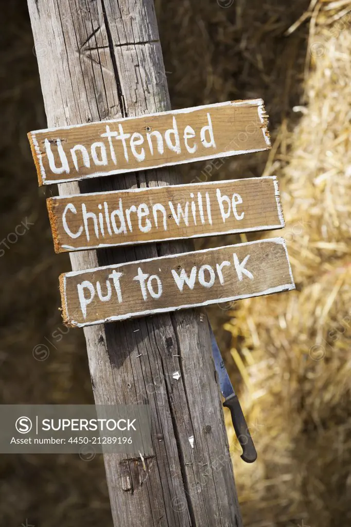 A handwritten sign, Unattended children will be put to work