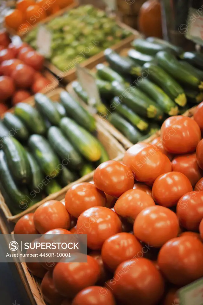 A farm stand display of organic vegetables. Produce. tomatoes and cucumbers. Accord, New York, USA
