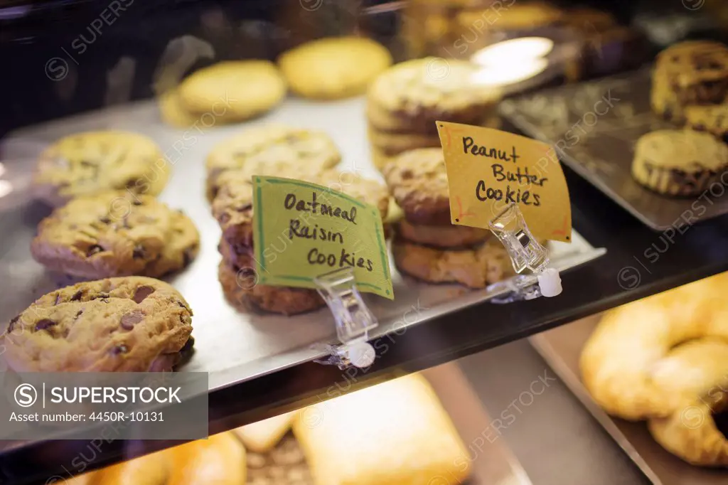 A tray of cookies, biscuits and baked goods on the counter at a coffee shop. Labels. Freshly home baked snacks. Kingston, New York, USA