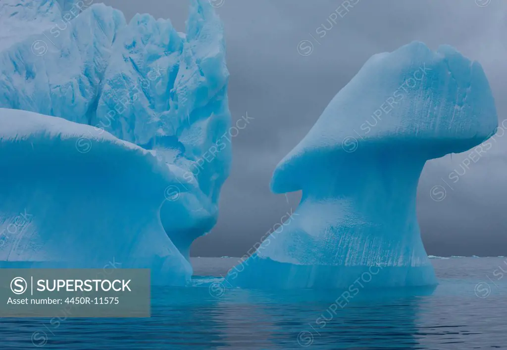 Icebergs with eroding and changing form drifting on the water, Antarctica Antarctica