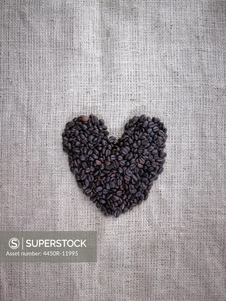 Organic roasted coffee beans in a heart shape on a burlap sack.  Woodstock, New York, USA
