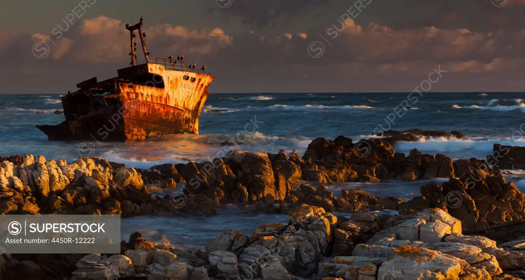 A rusting wreck, an abandoned ship off the shore of Arniston, on the shores of Cape South.  Cape Agulhas, Arniston, South Africa