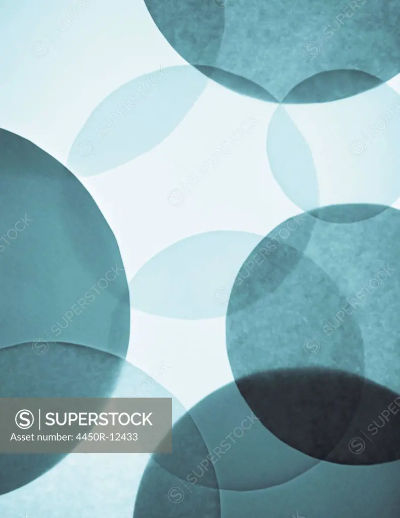Overlapping circular shapes in various shades of blue.