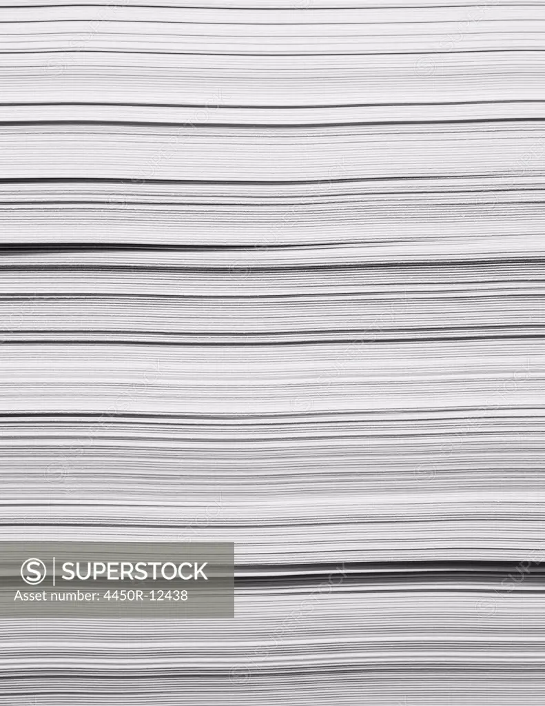 A stack of recycled white paper, paper supplies. The paper edges.