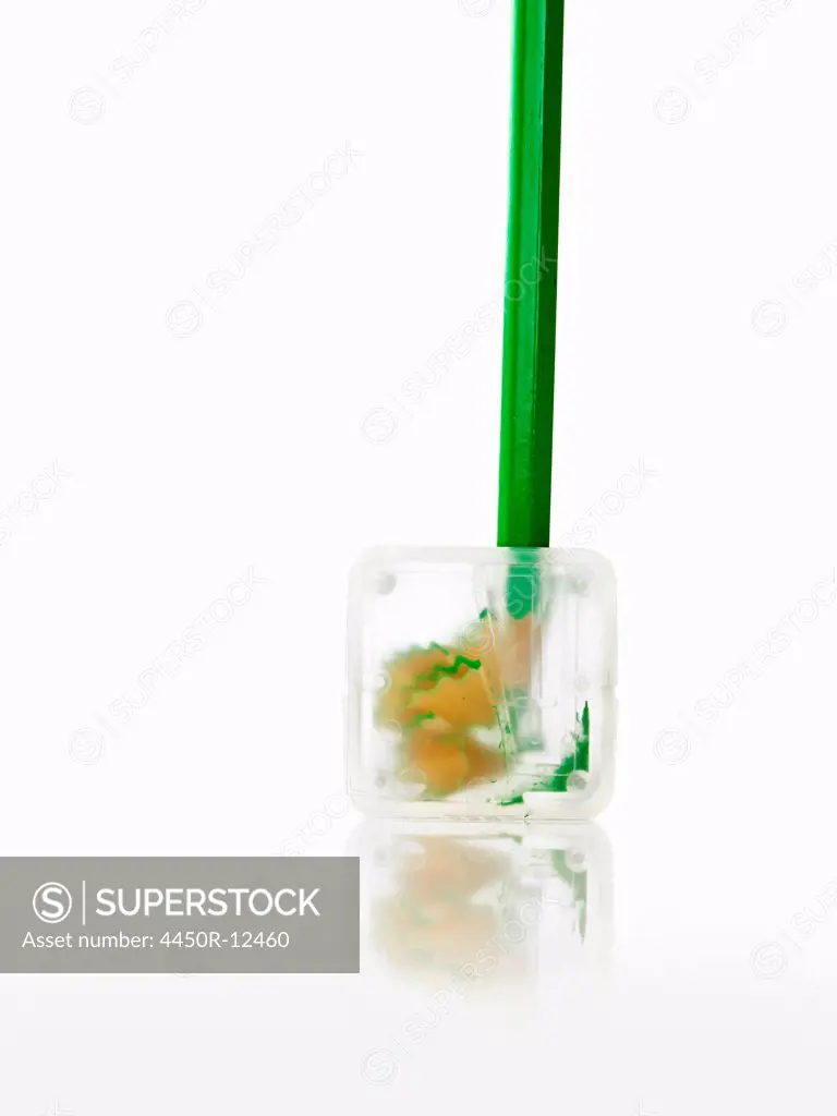 A green pencil and clear plastic pencil sharpener. New York City, USA