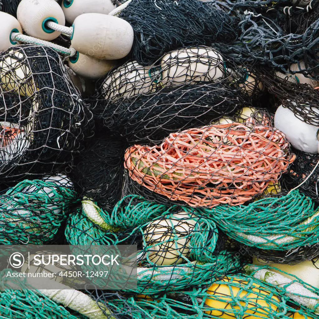 Pile of commercial fishing nets, with white floats, on the quayside at Fisherman's Terminal, Seattle. Seattle, Washington, USA