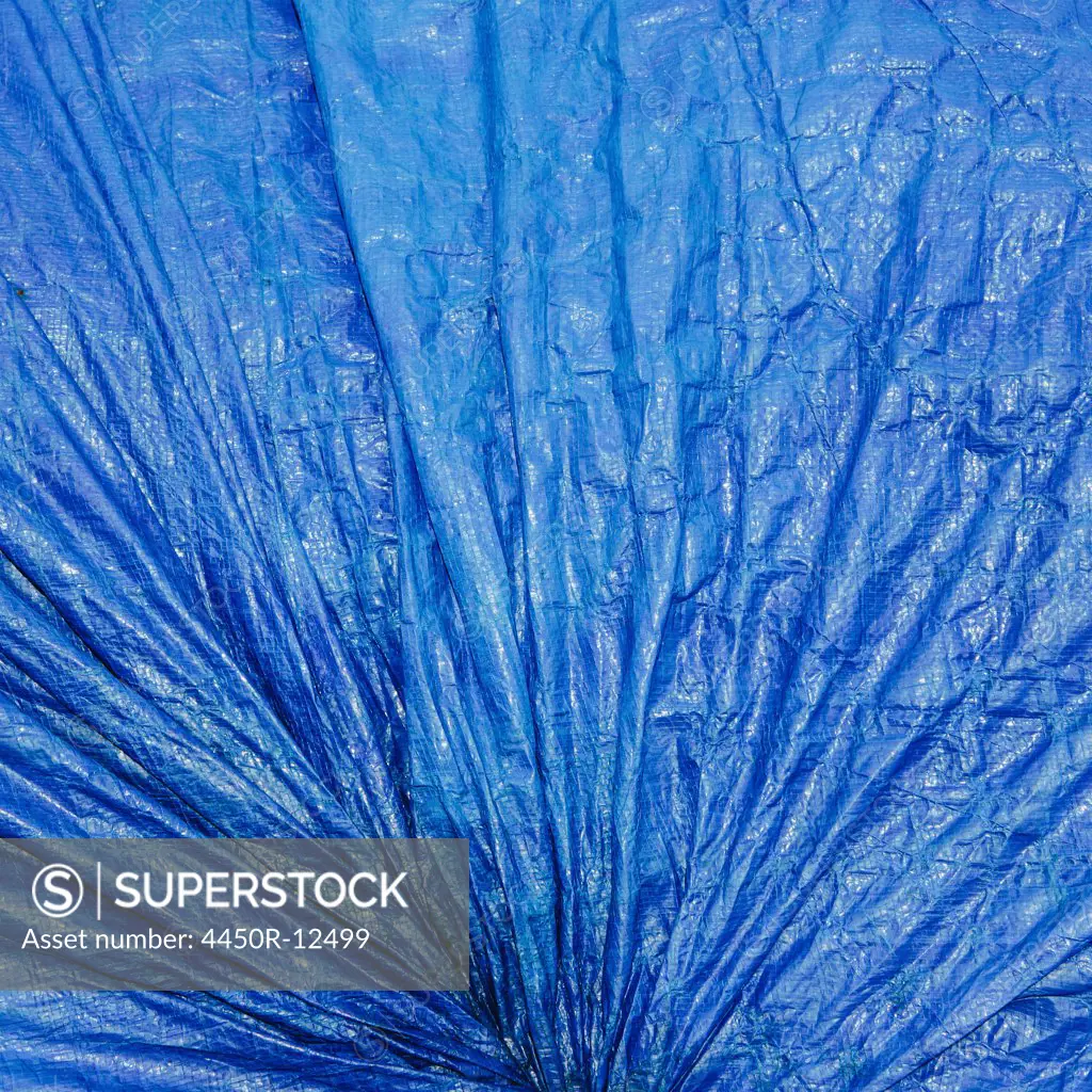 a blue tarpaulin covering gathered and tied as a covering over commercial fishing nets, Fisherman's Terminal, Seattle Seattle, Washington, USA