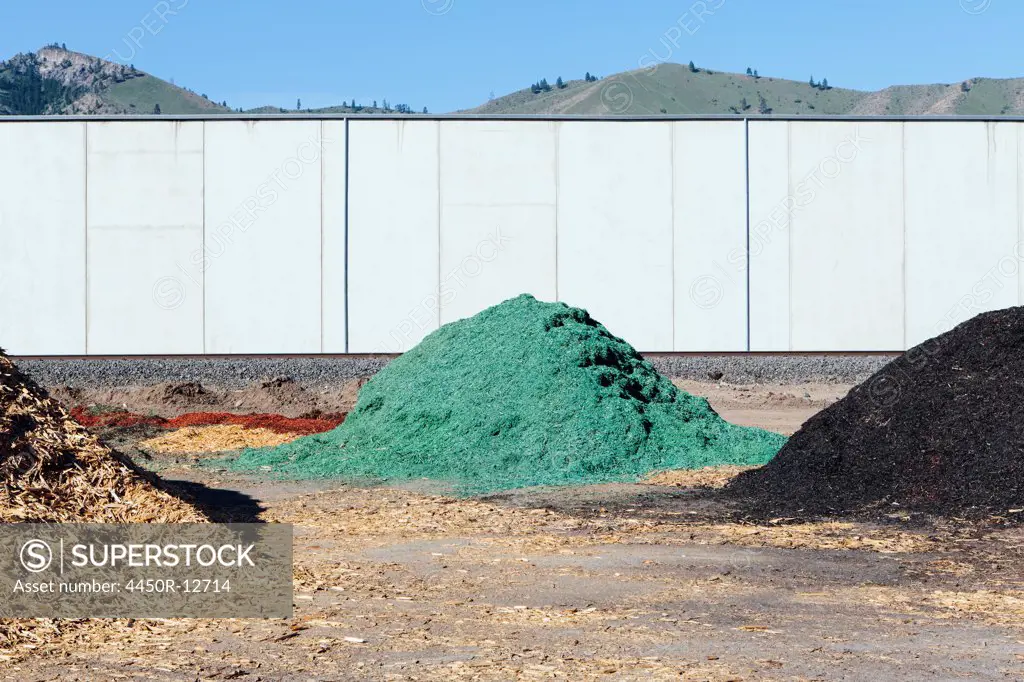 Piles of green bark wood chips used for landscaping, near Quincy Quincy, Grant County, Washington, USA