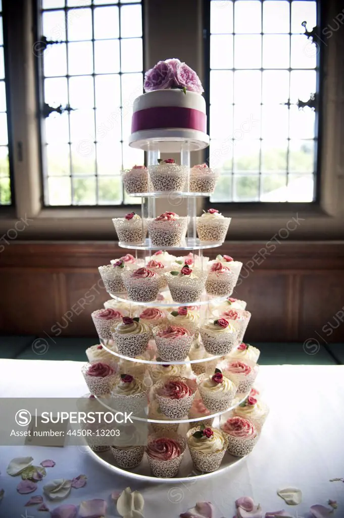 Frosted cupcakes on a seven tier cake stand, a cupcake wedding cake. England. 07/10/2010