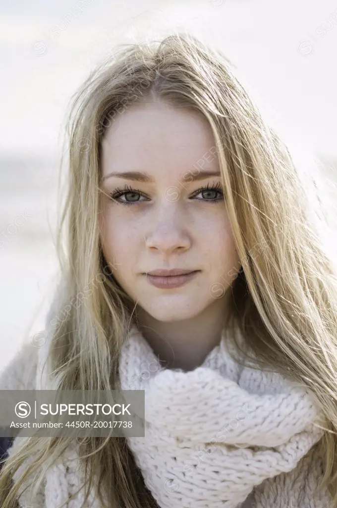 A young girl with blonde hair looking at the camera.