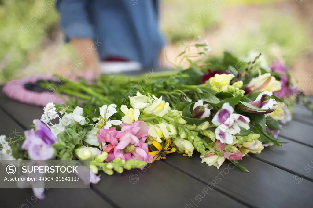 A bunch of summer garden flowers on an outdoor table.