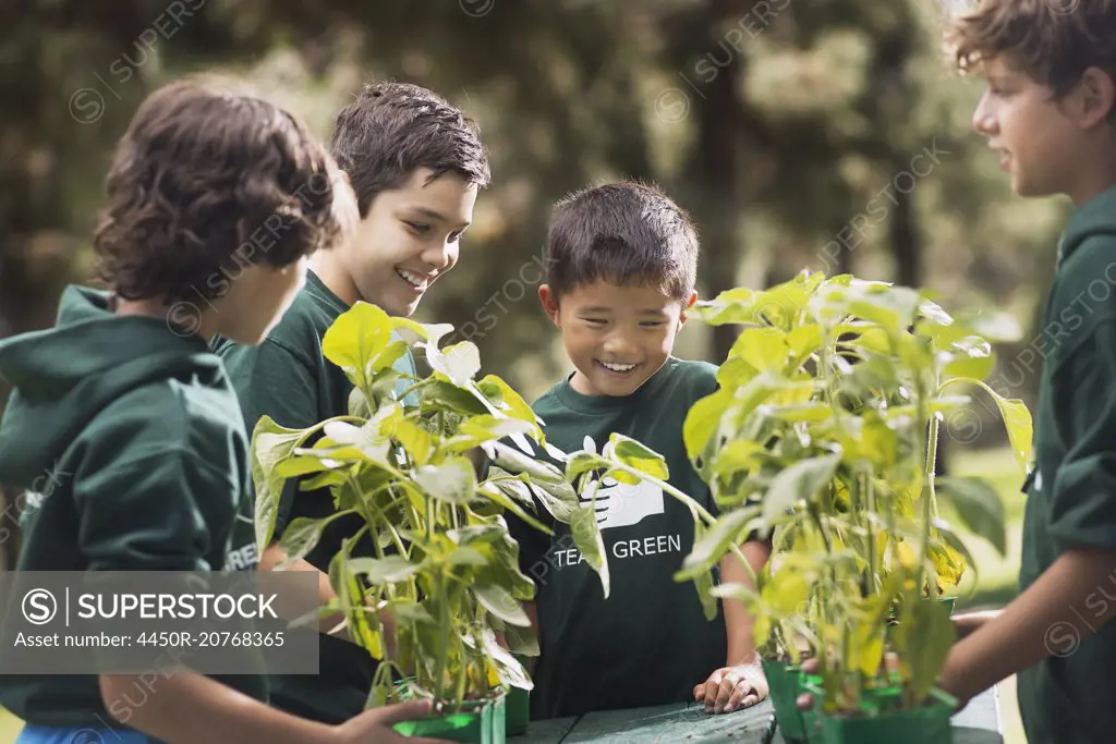 Children in a group learning about plants and flowers, in an afterschool club or summer camp.