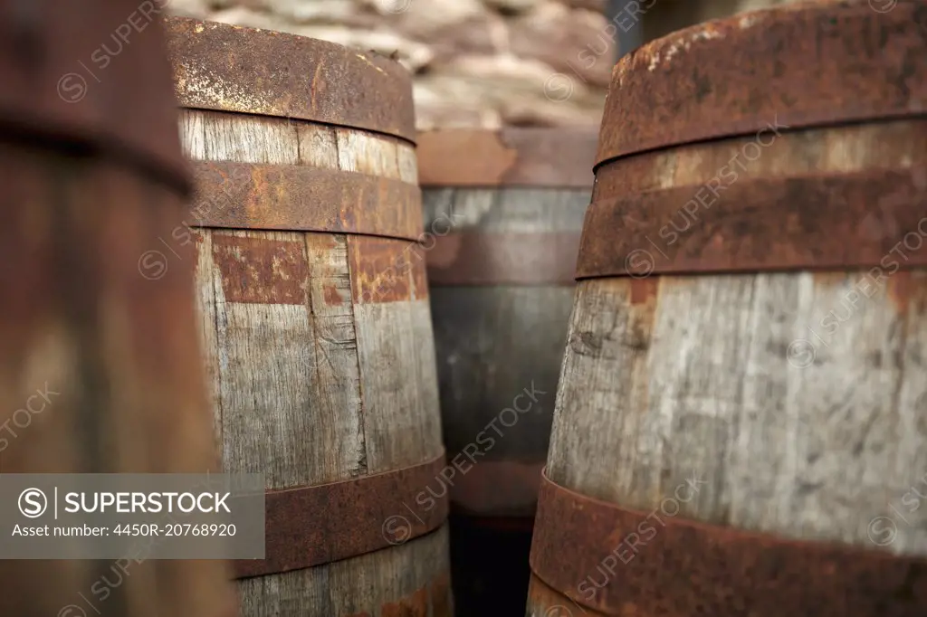 Wooden barrels in a barn at a cider press.
