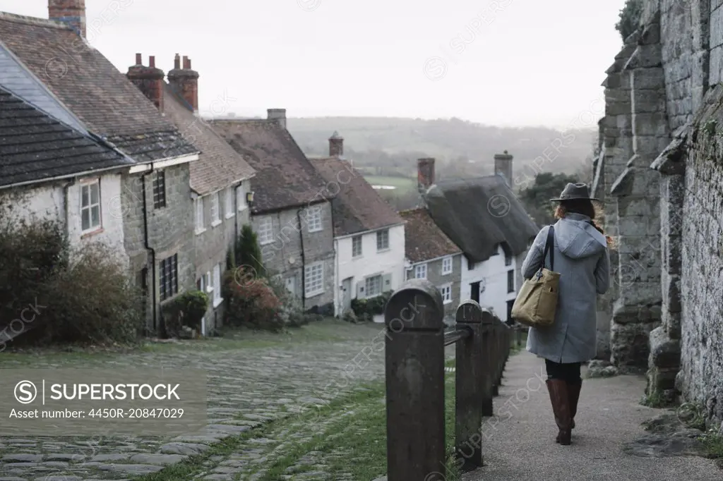 A woman at the top of Gold Hill, a steep cobbled street in Shaftesbury.