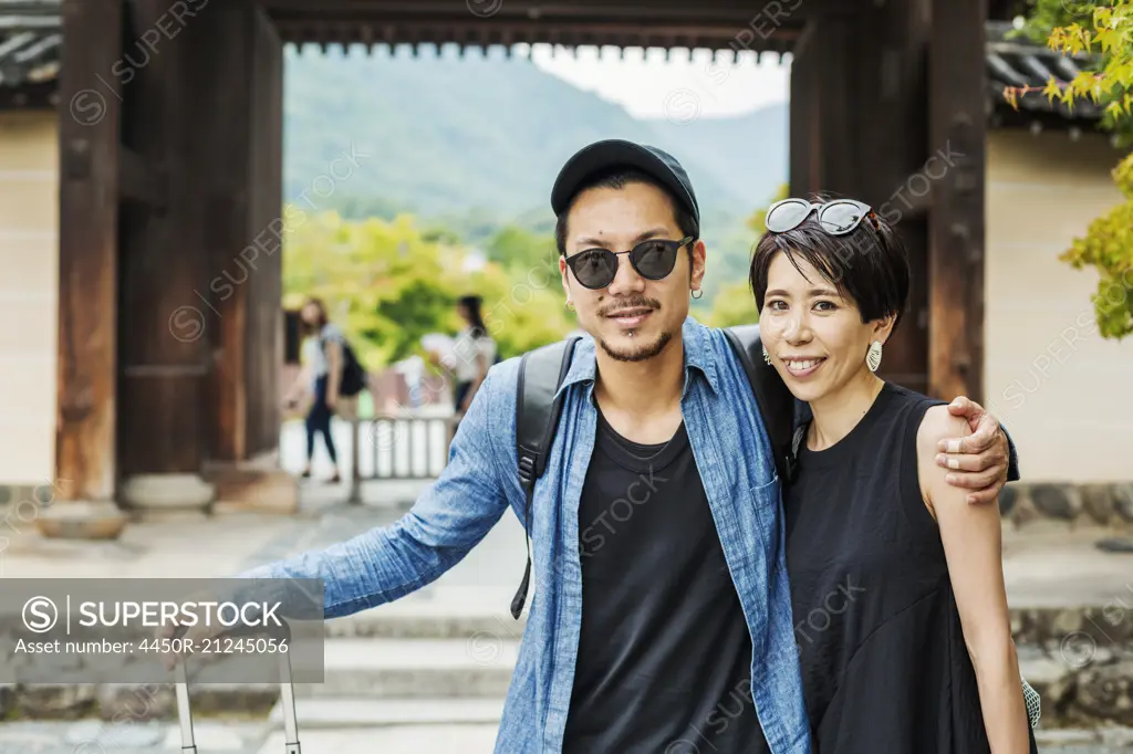 A man and woman visiting a historic temple in Japan.