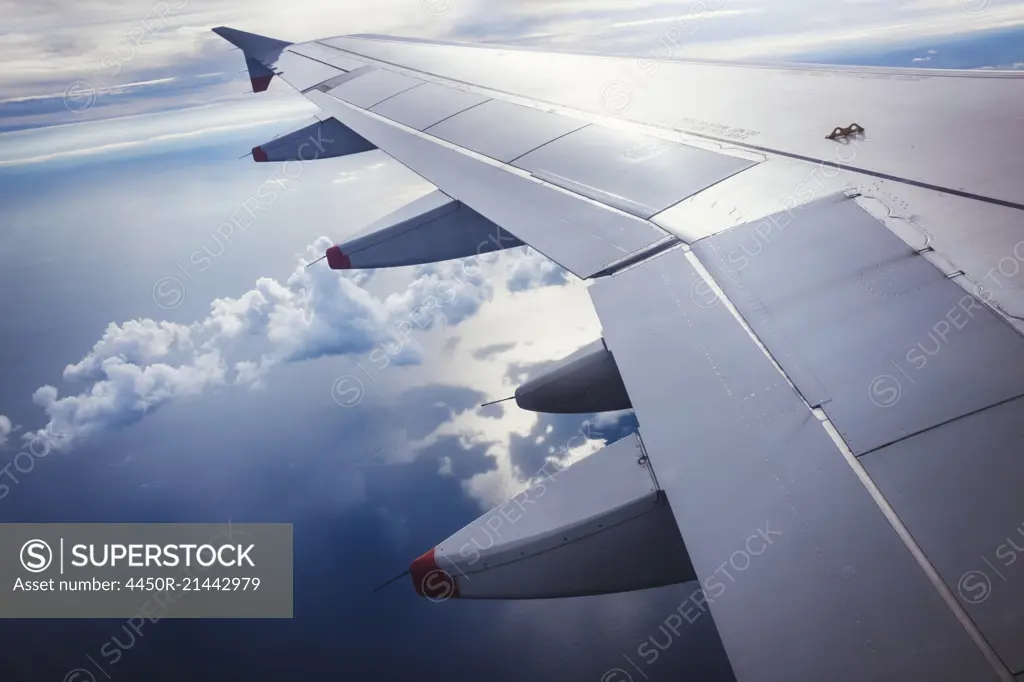 View from an aircraft window of an aeroplane wing, in flight.