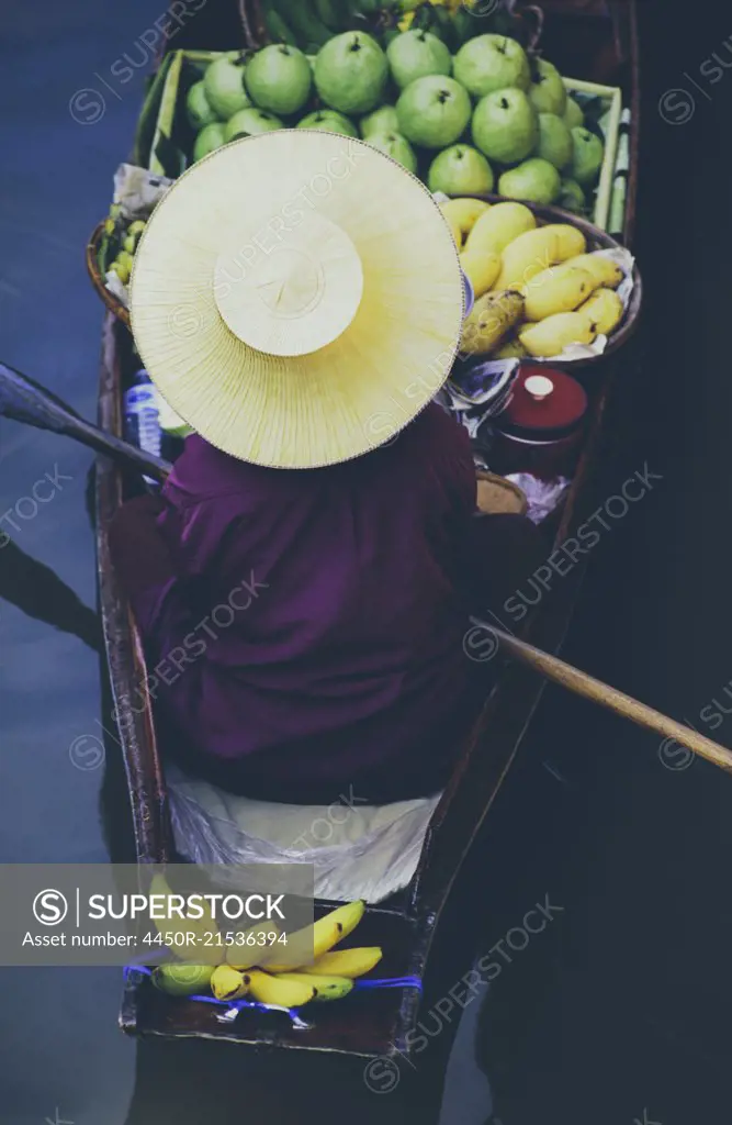 Damnoen Saduak Floating Market, a woman selling goods from boats in floating market