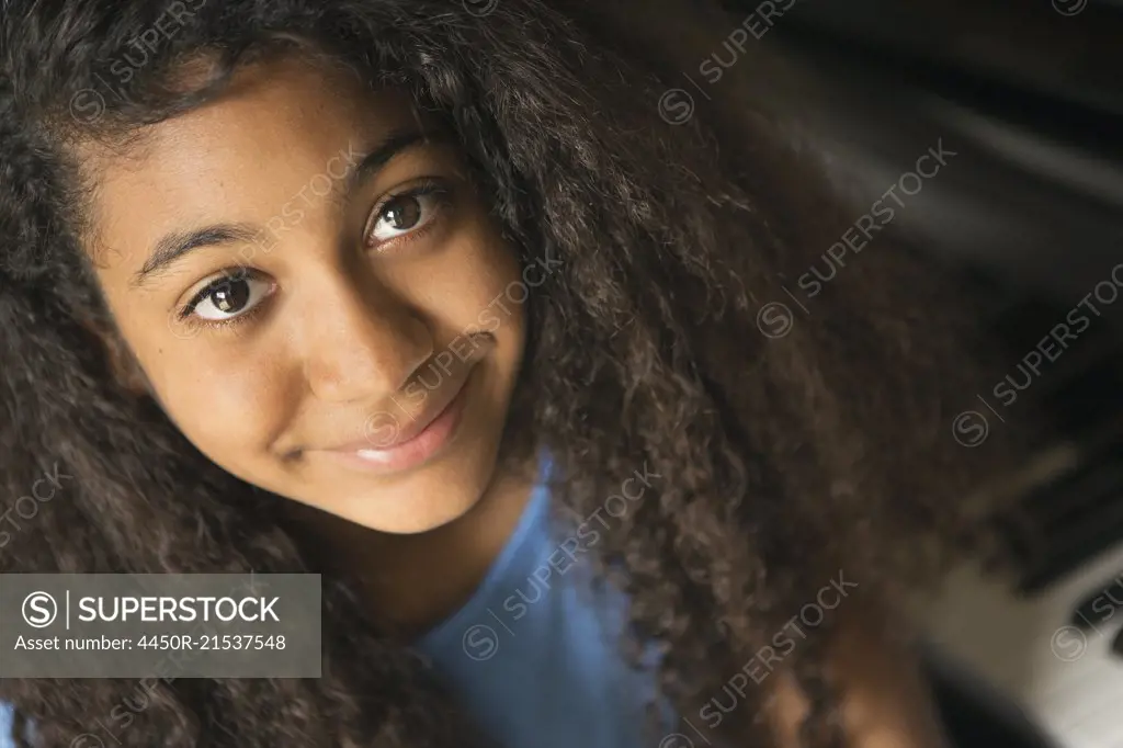 A young teenage girl smiling, portrait.