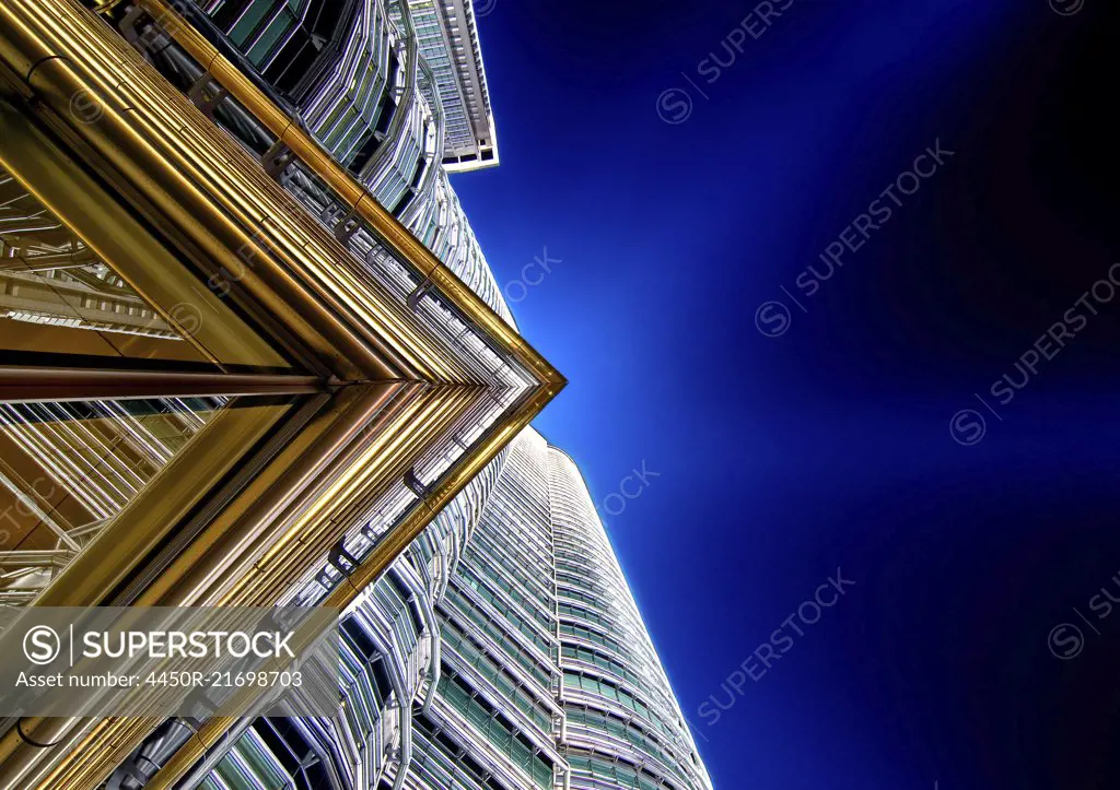 Low angle close up of architectural detail on Petronas Towers in Kuala Lumpur, Malaysia at night.