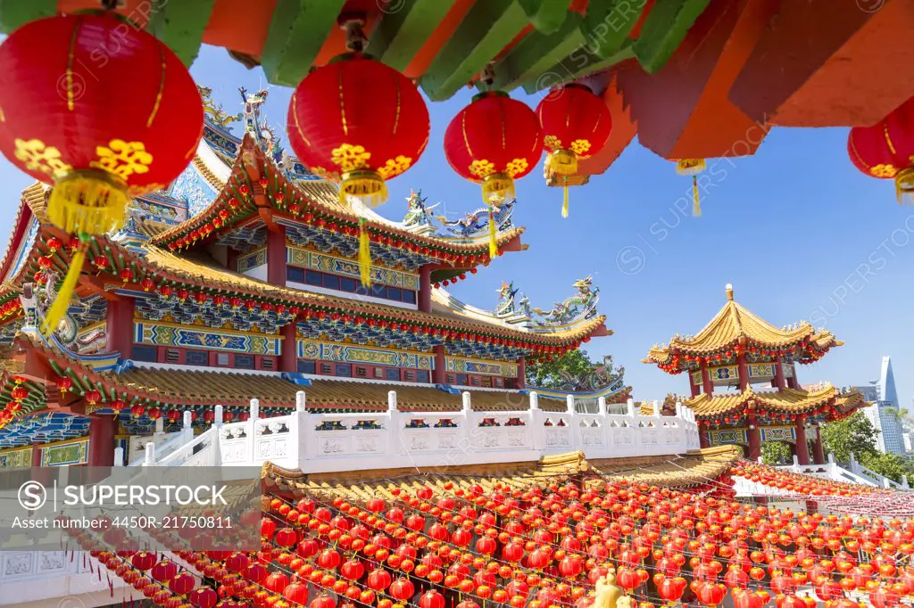 Colourful Chinese temple decorated with an abundance of traditional red paper lanterns.
