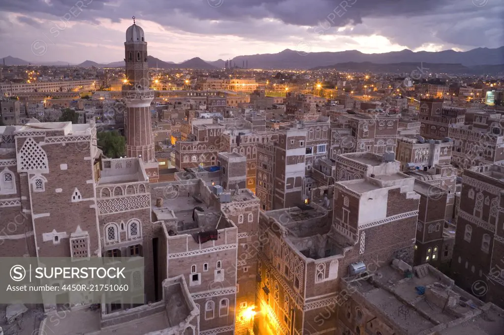High angle view over rooftops of buildings in the old city of Sana'a in Yemen. A UNESCO world heritage site with traditional architecture, houses of many storeys with decorative friezes.