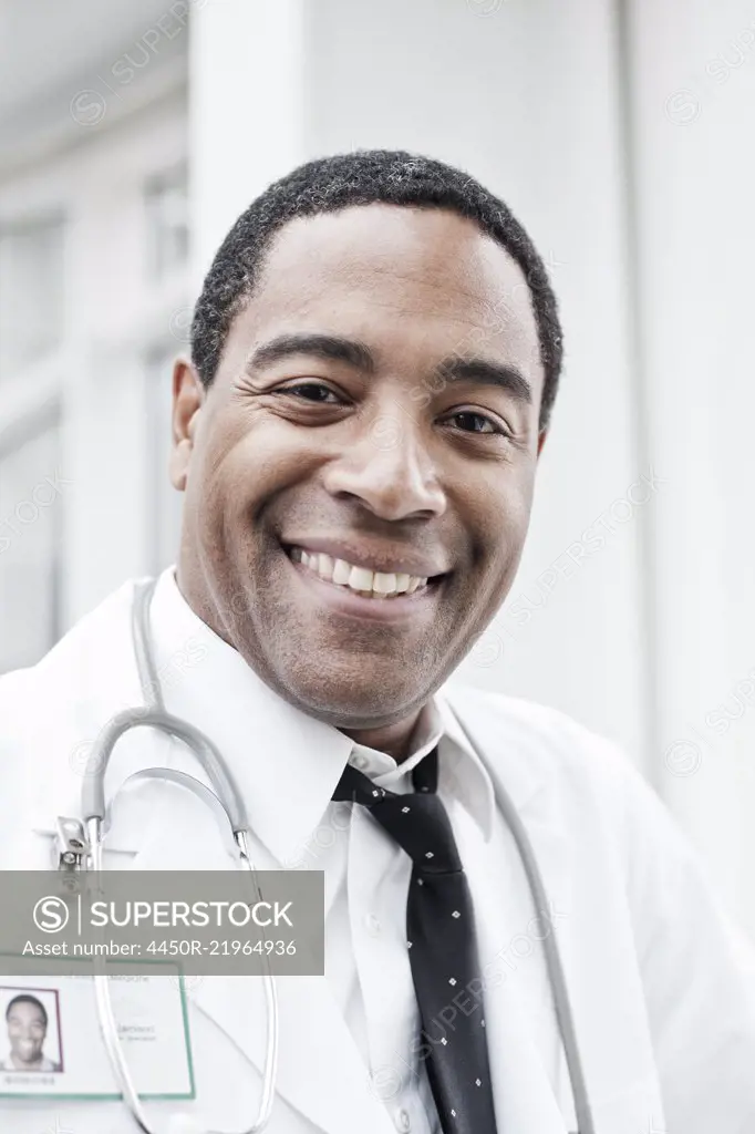 Black man doctor in lab coat with a stethoscope.