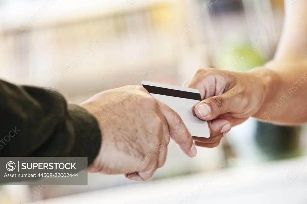 A closeup of a credit card transaction taking place.
