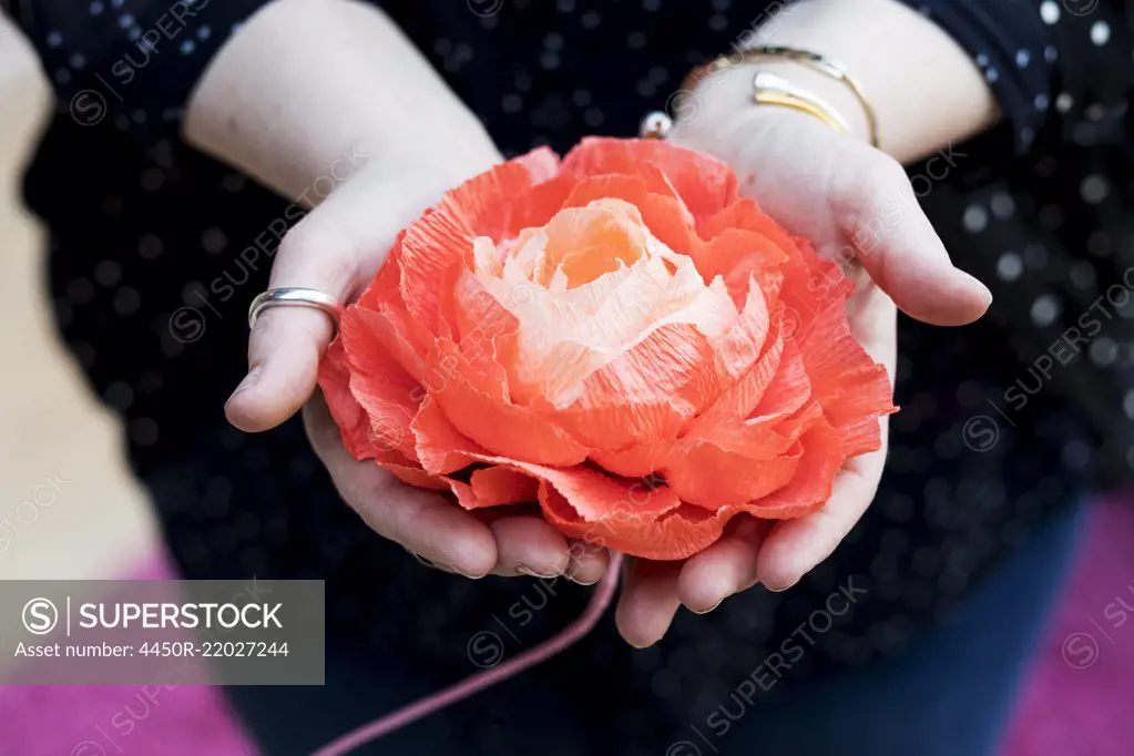 Close up of woman holding handcrafted fabric flowers.