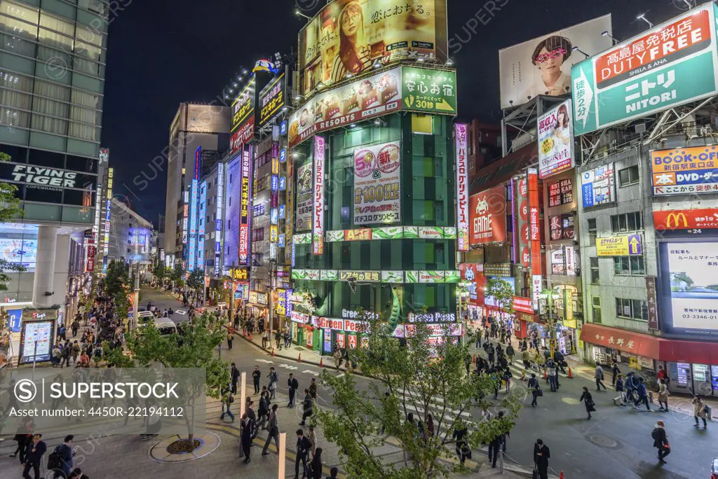 Street view with illuminated advertising boards at night, Shinjuku, Tokyo, Japan.