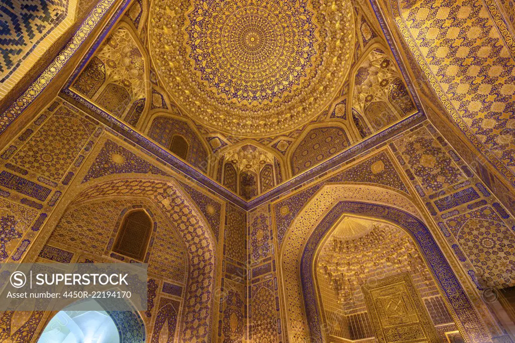 Interior, the blue and yellow glazed walls and dome of a Madrasa building in Samarkand.
