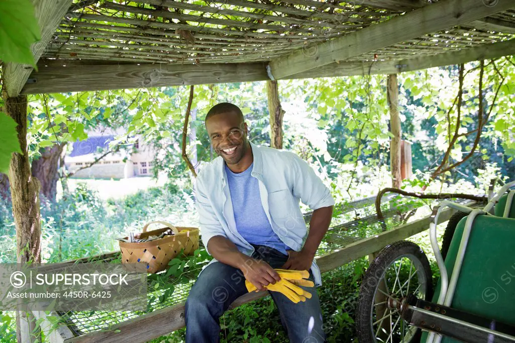 A farm growing and selling organic vegetables and fruit. A man working.