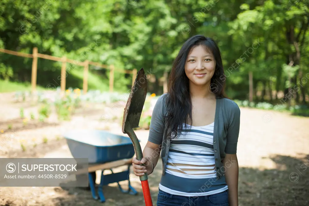 A young woman on a traditional farm in the countryside of New York State, USA. Woodstock, New York, USA. 7/5/2012